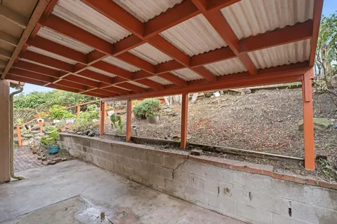 a view of a room with wooden walls and outdoor space