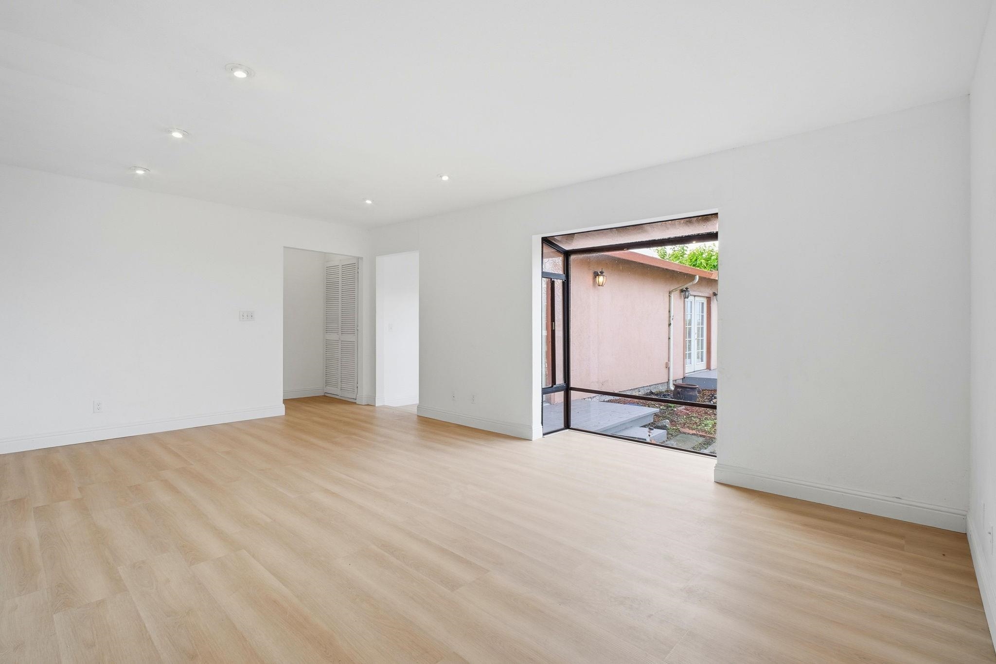 14683 Midland Road San Leandro, CA 94578 - Photo 8 of 31 a view of an empty room with wooden floor and a window