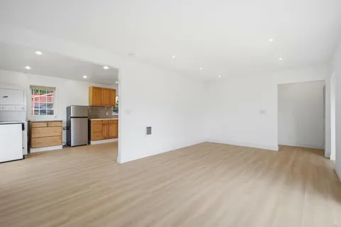 a view of a kitchen with a sink and a refrigerator