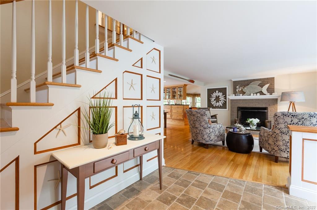 29 Twin Coves Road Madison, CT 06443 - Photo 1 of 1 a living room with furniture a rug and a fireplace