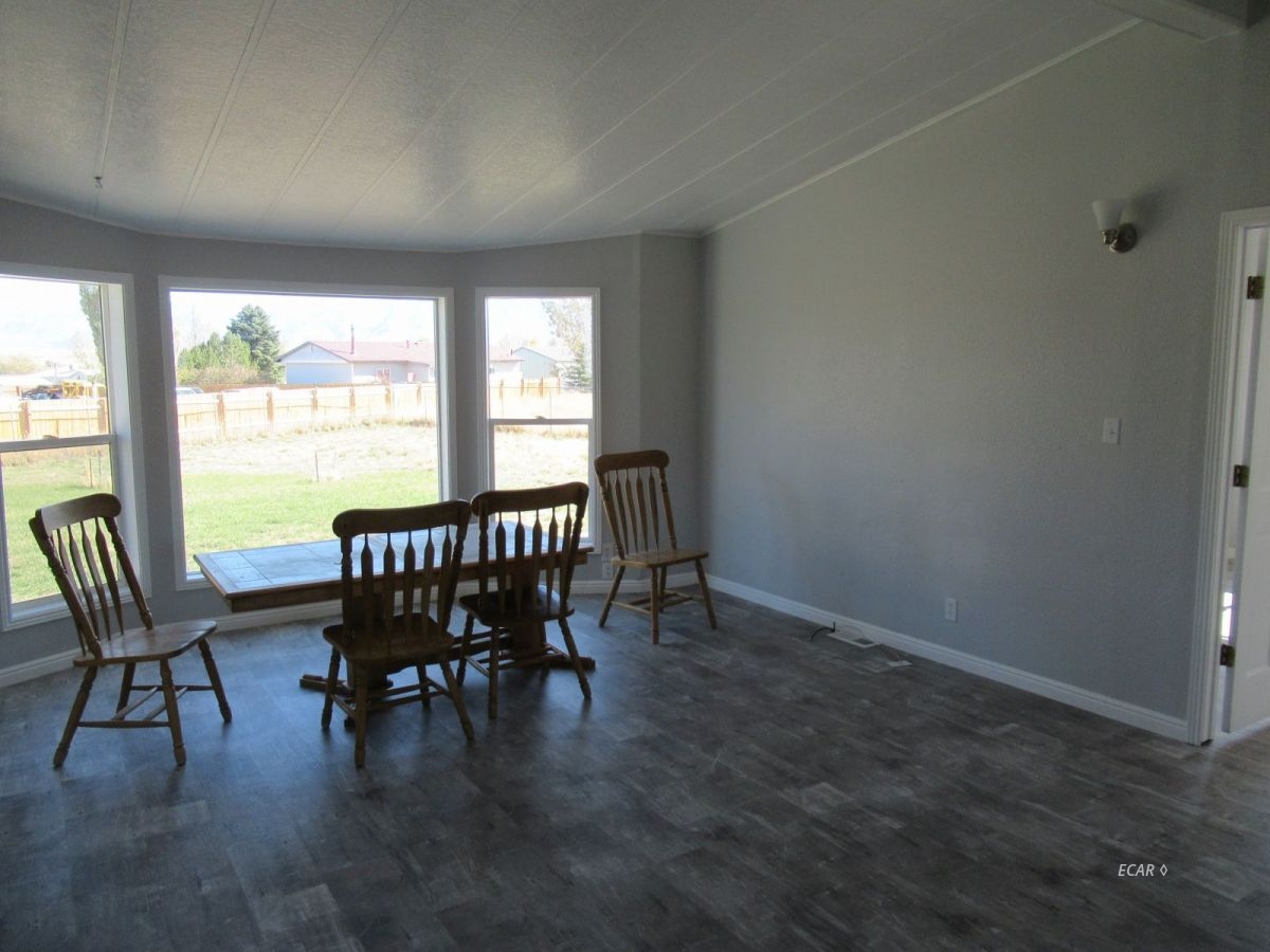 957 Spring Valley Parkway Spring Creek, NV 89815 - Photo 2 of 18 a view of a dining room with furniture window and outside view