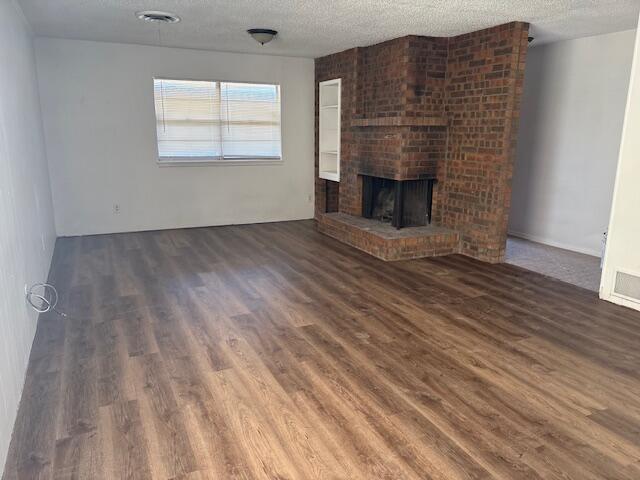 5520 18th Street Lubbock, TX 79416 - Photo 2 of 4 an empty room with wooden floor fireplace and windows