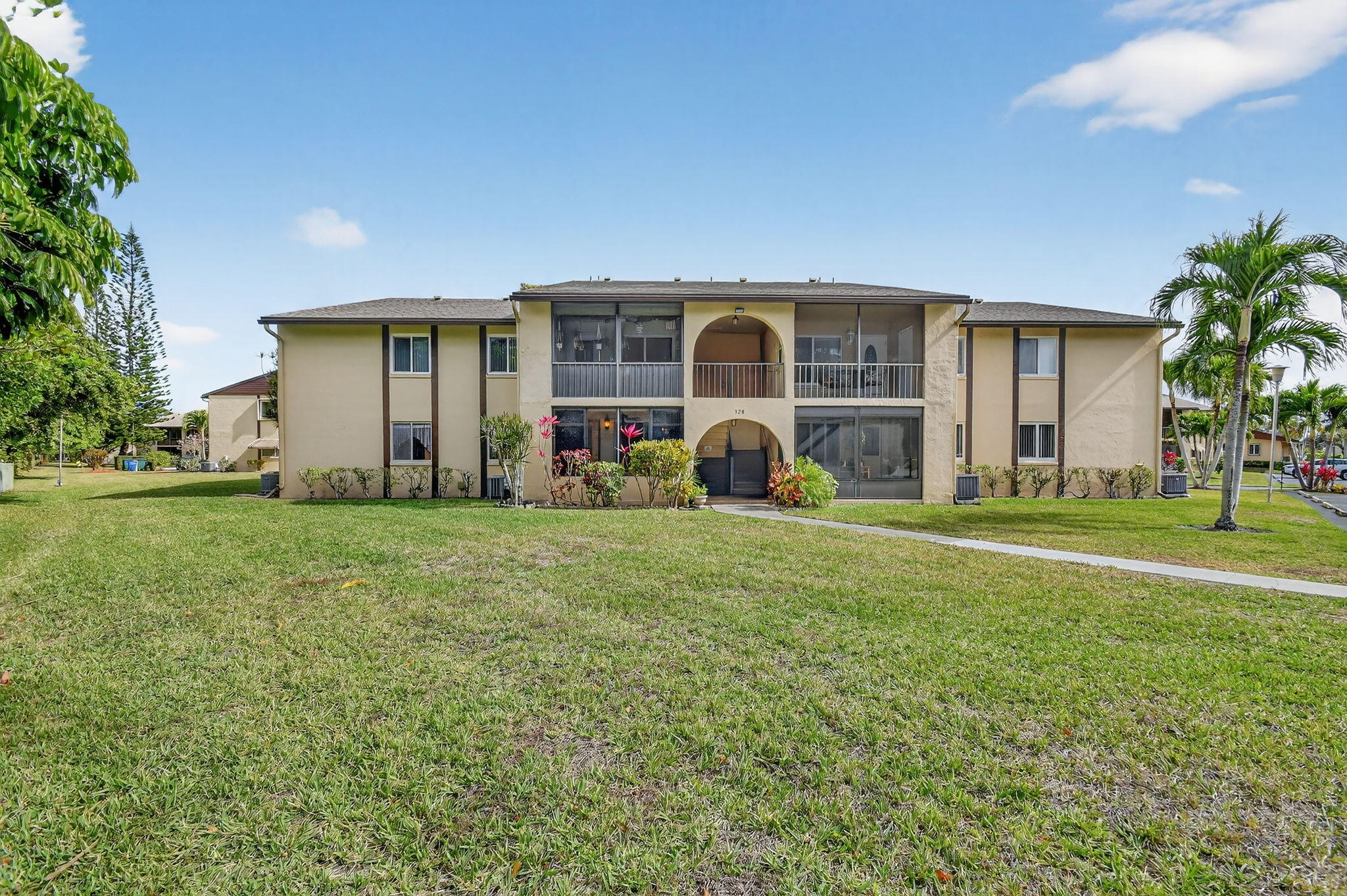 328 Pine Ridge Circle, Unit C1 Greenacres, FL 33463 - Photo 1 of 47 a front view of house with yard and green space