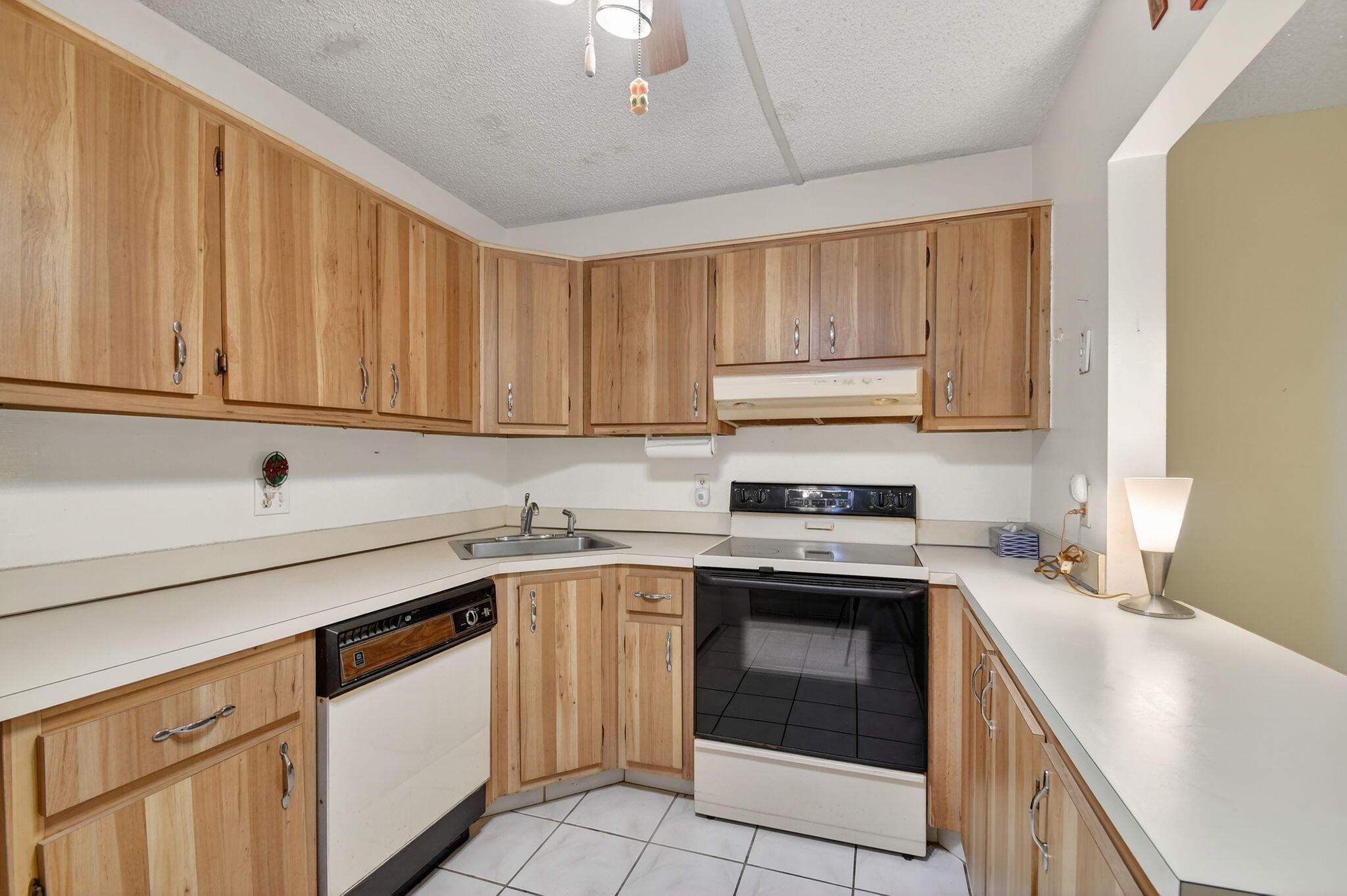 328 Pine Ridge Circle, Unit C1 Greenacres, FL 33463 - Photo 15 of 47 a kitchen with a sink stove and cabinets