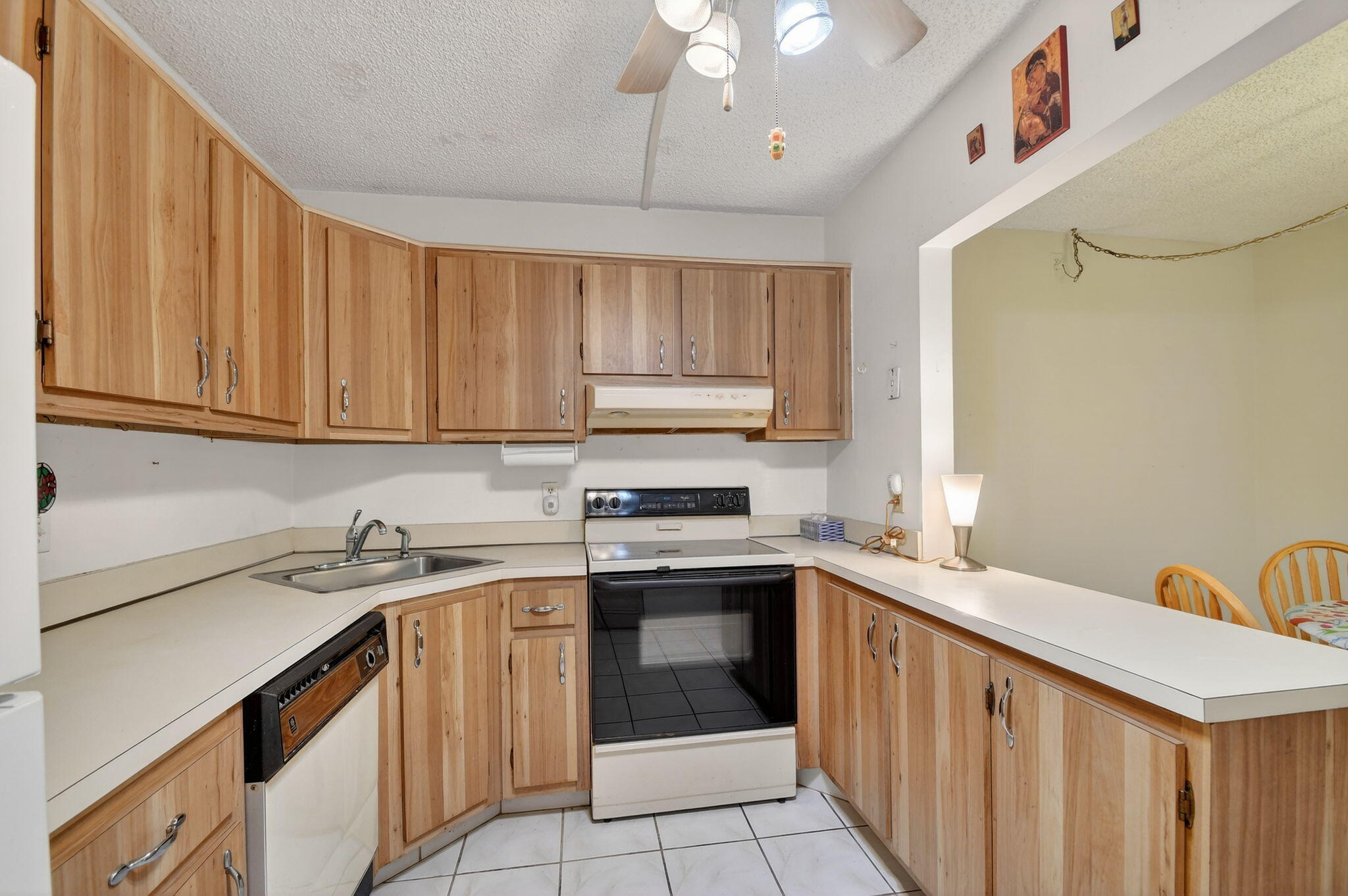 328 Pine Ridge Circle, Unit C1 Greenacres, FL 33463 - Photo 16 of 47 a kitchen with a sink stove and cabinets
