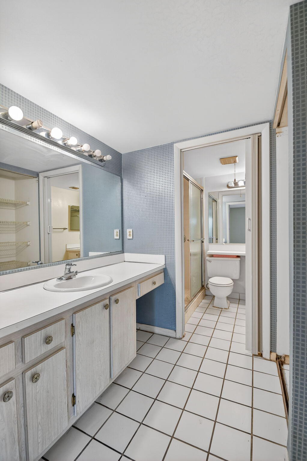 328 Pine Ridge Circle, Unit C1 Greenacres, FL 33463 - Photo 25 of 47 a spacious bathroom with a sink and a mirror