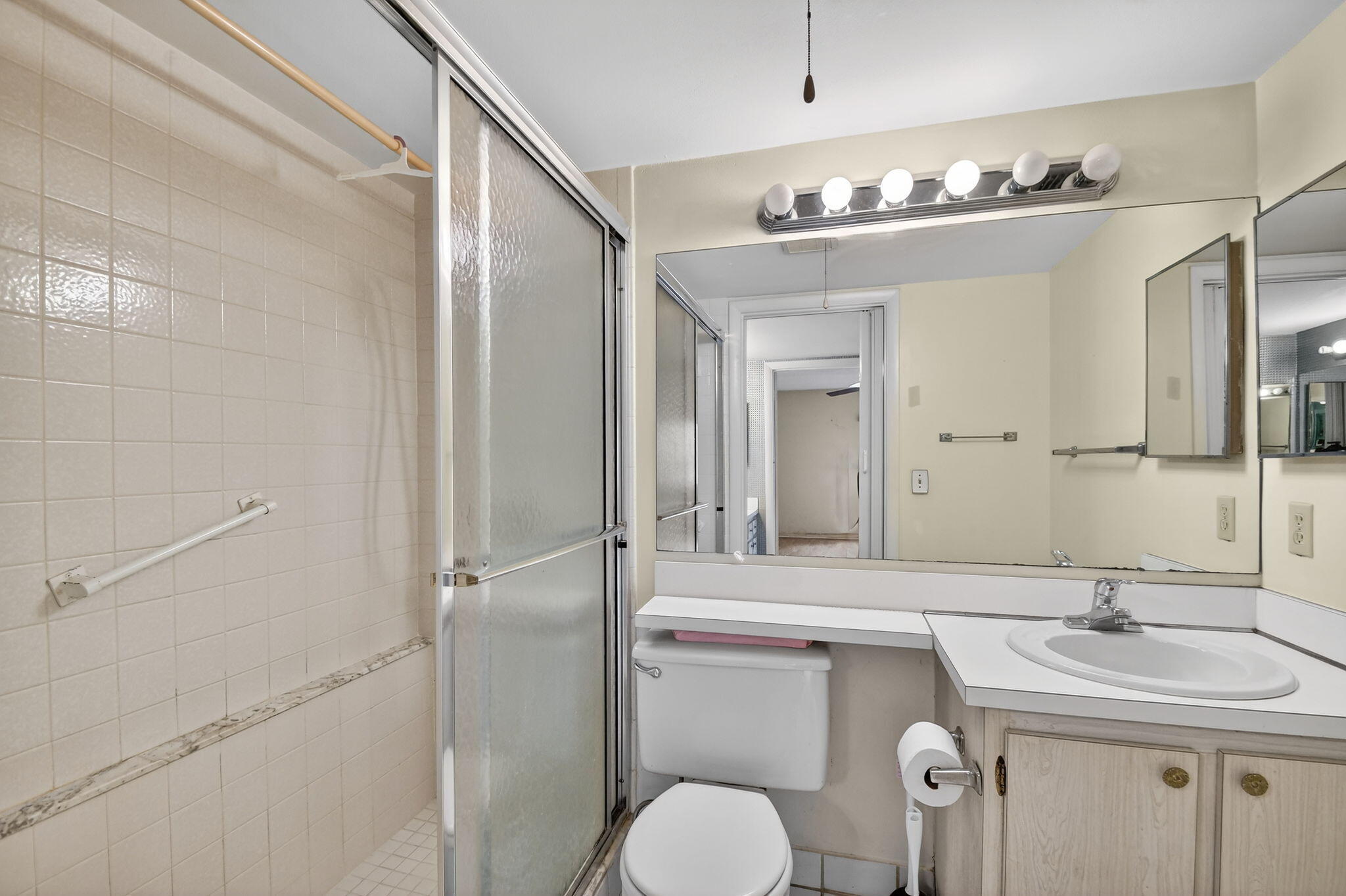 328 Pine Ridge Circle, Unit C1 Greenacres, FL 33463 - Photo 26 of 47 a bathroom with a sink a toilet and mirror