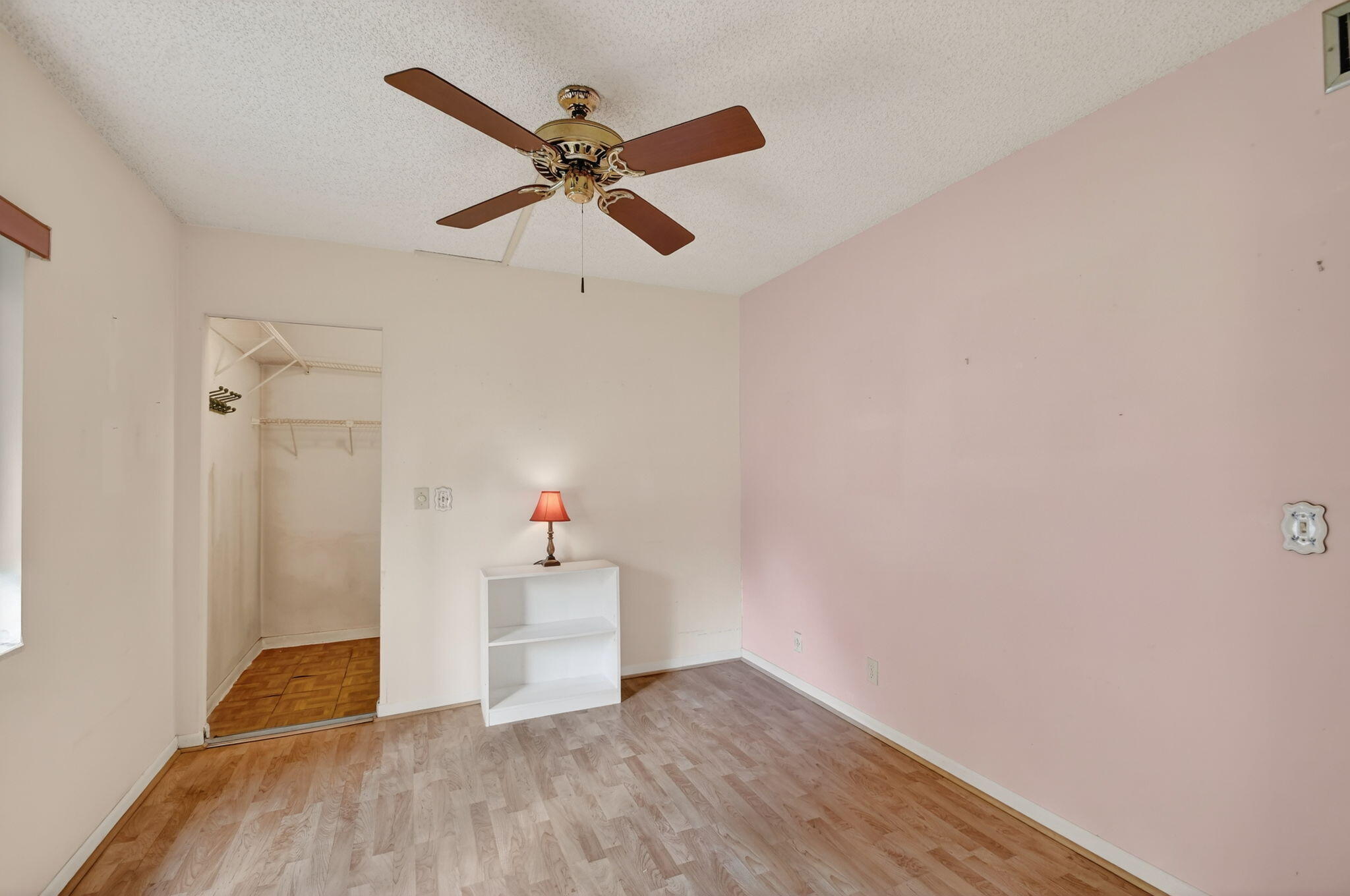 328 Pine Ridge Circle, Unit C1 Greenacres, FL 33463 - Photo 29 of 47 a view of an empty room with wooden floor and a ceiling fan
