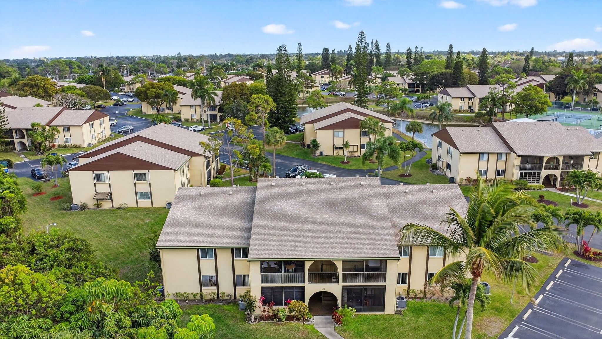 328 Pine Ridge Circle, Unit C1 Greenacres, FL 33463 - Photo 32 of 47 a aerial view of a house with garden and trees