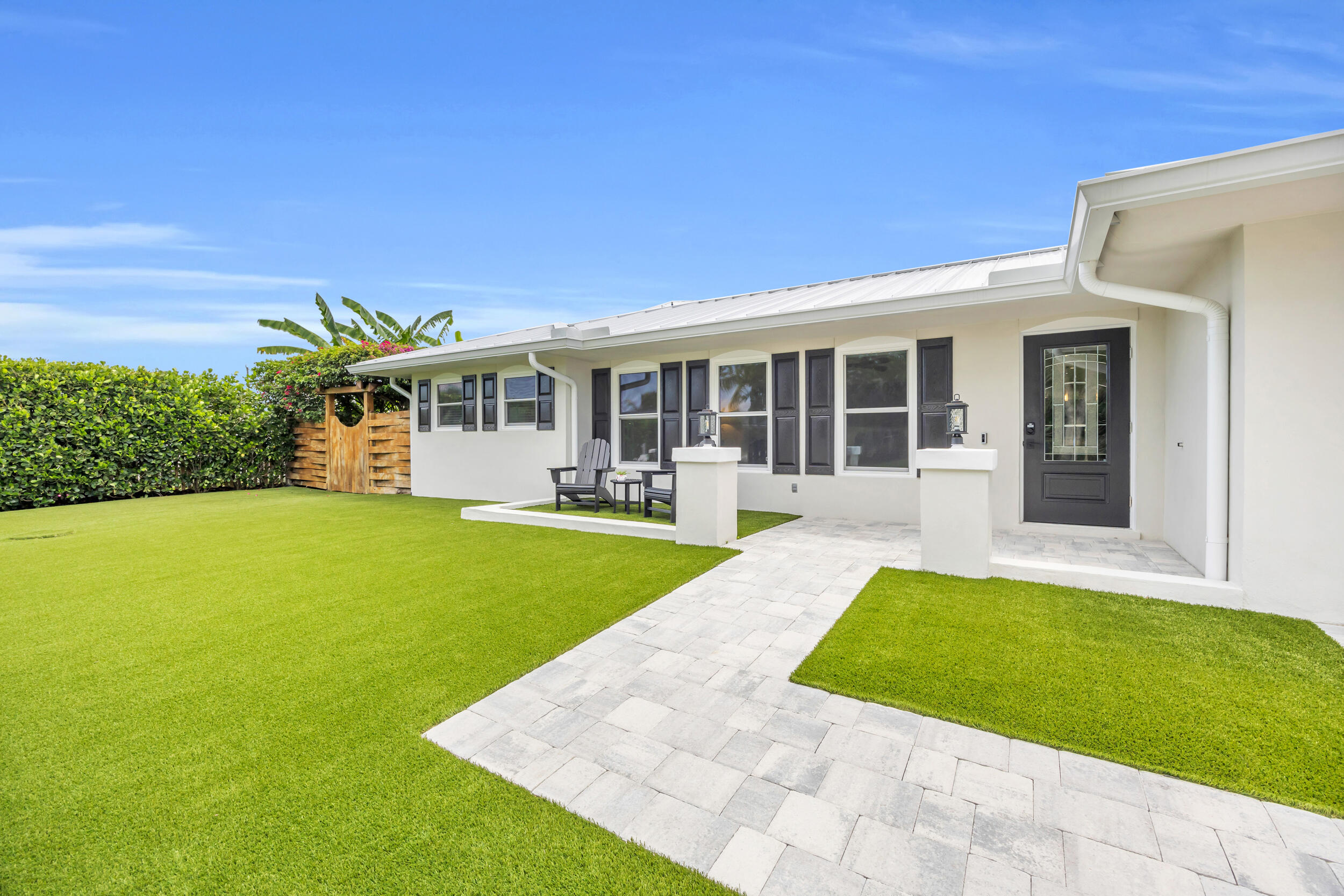 a view of a house with a swimming pool and a yard