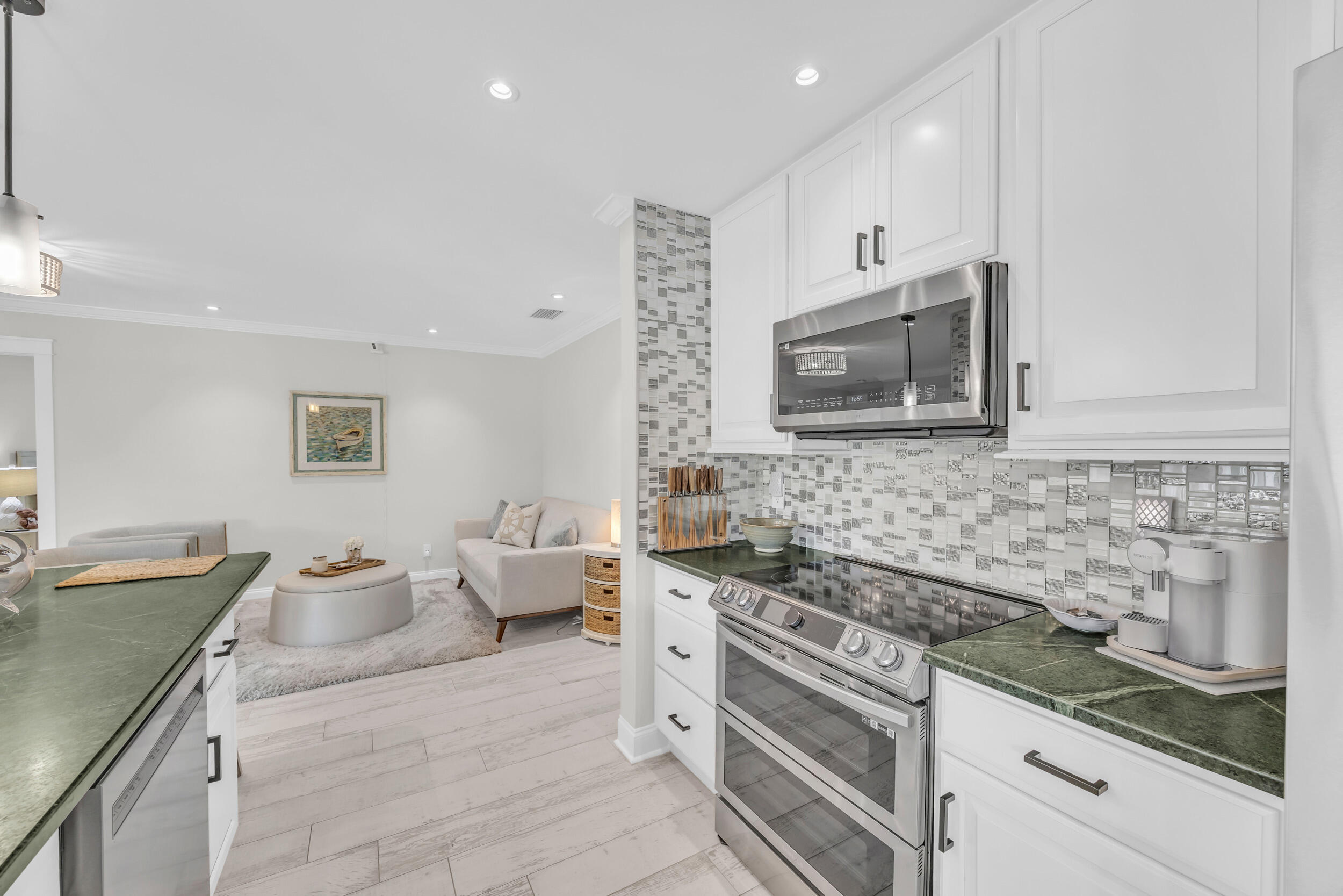 11 Southeast Splitrail Circle Jupiter, FL 33469 - Photo 16 of 48 a kitchen with stainless steel appliances granite countertop a sink and stove top oven