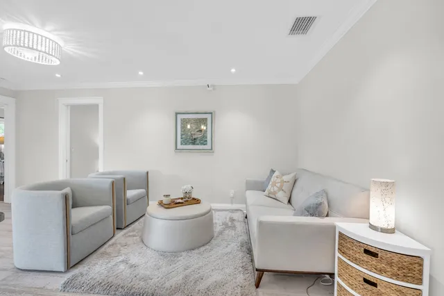 a living room with furniture and a lamp