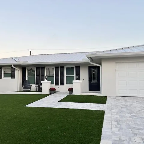 a front view of a house with a yard and porch