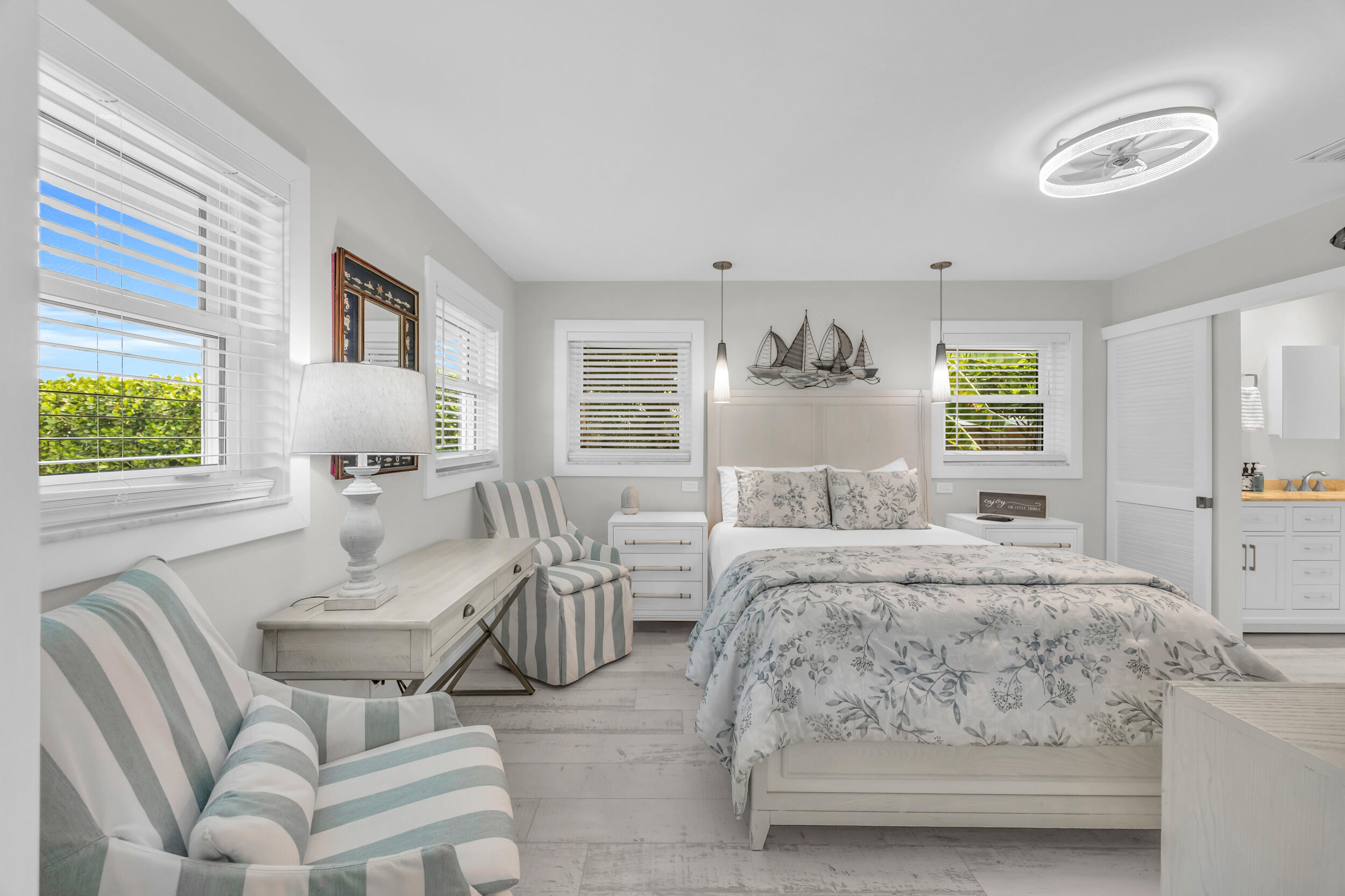 11 Southeast Splitrail Circle Jupiter, FL 33469 - Photo 22 of 48 a bedroom with a bed and wooden floor