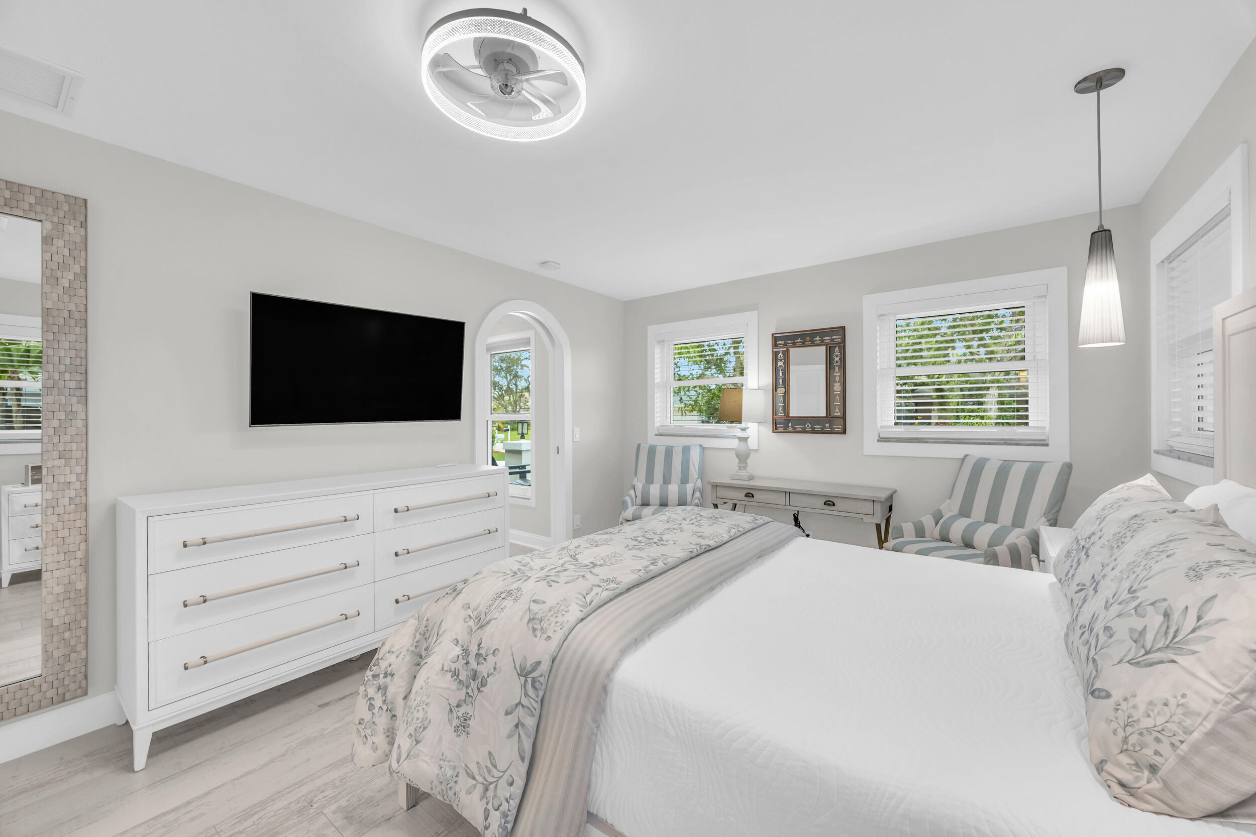 11 Southeast Splitrail Circle Jupiter, FL 33469 - Photo 24 of 48 a spacious bedroom with a bed and a flat screen tv