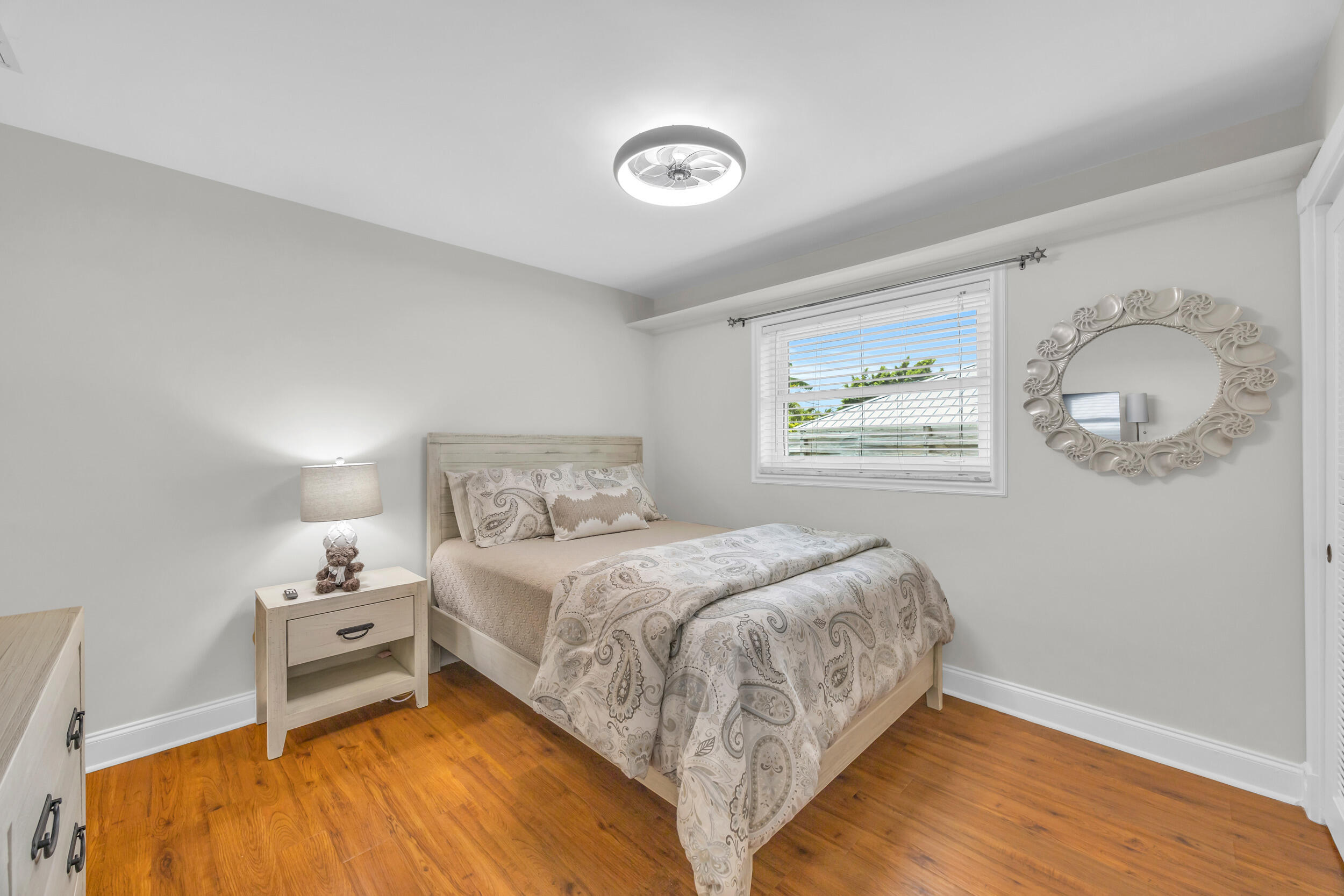 11 Southeast Splitrail Circle Jupiter, FL 33469 - Photo 28 of 48 a bedroom with a bed and a window