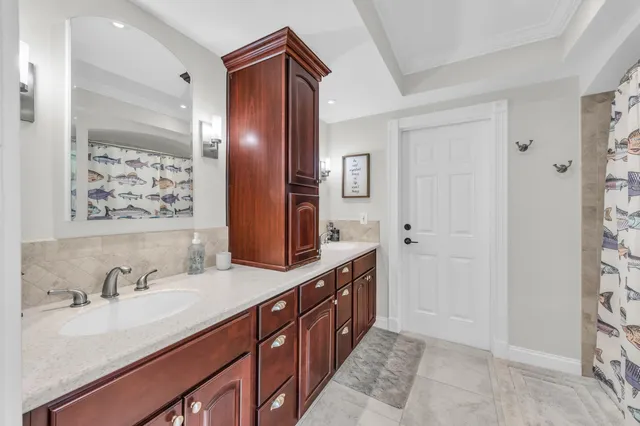 a bathroom with double vanity sink and a mirror