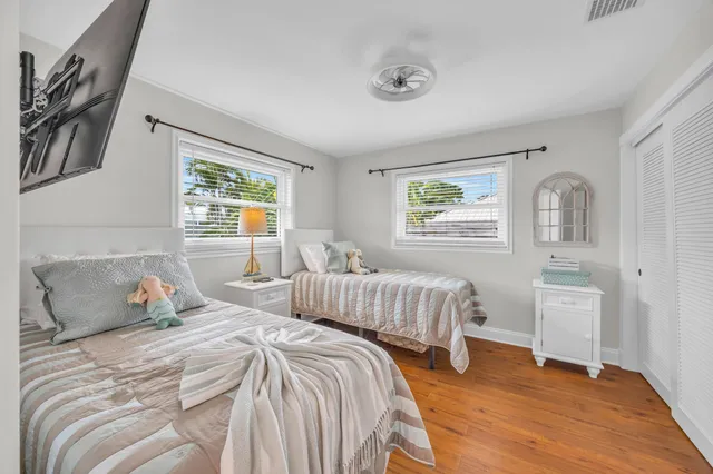 a bedroom with two beds and a window