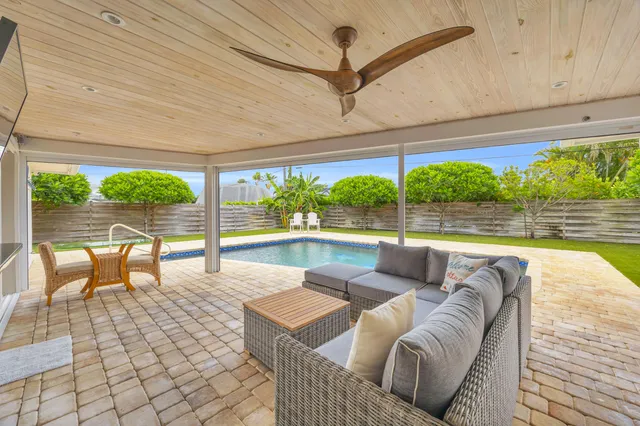 a living room with furniture and a floor to ceiling window
