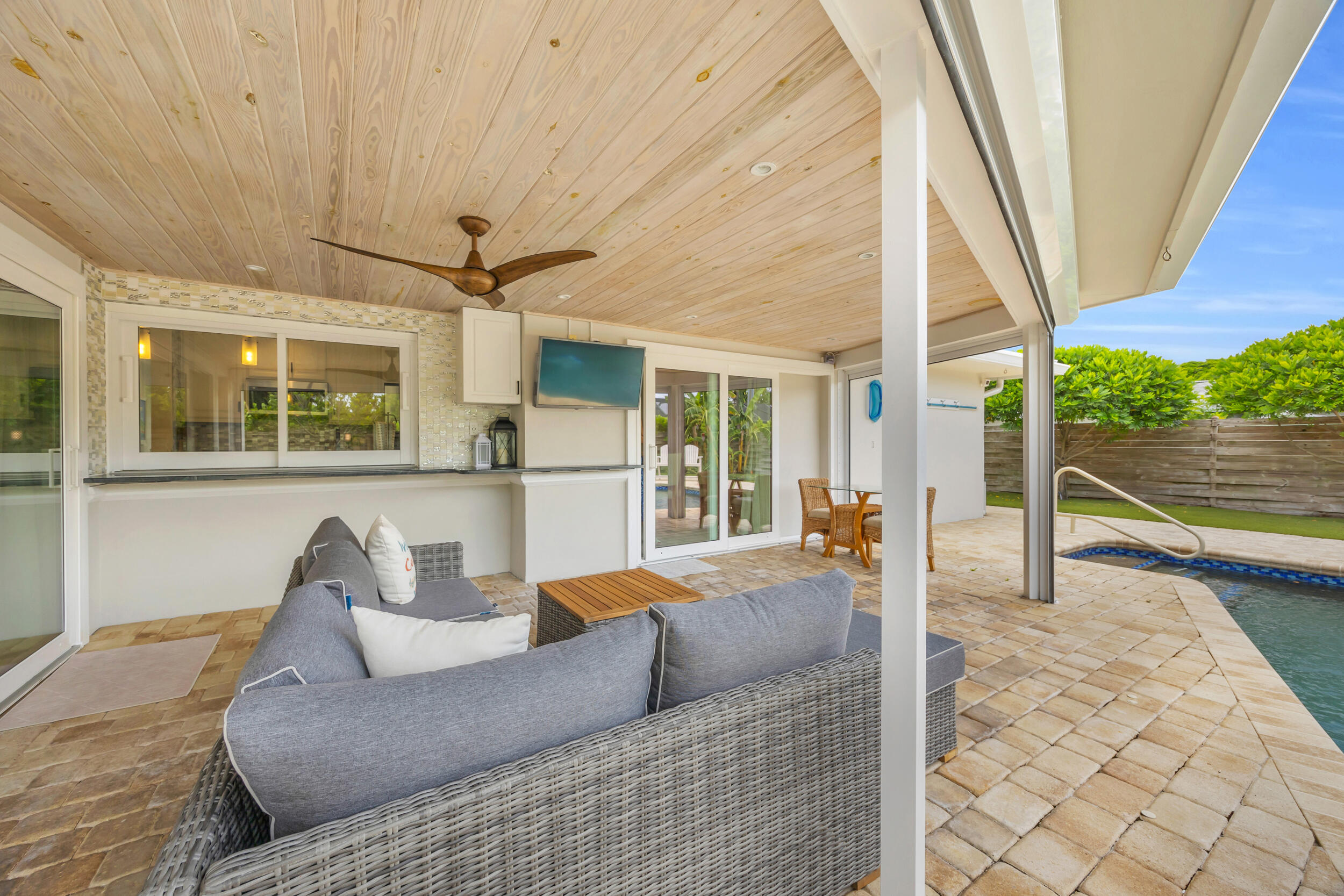 11 Southeast Splitrail Circle Jupiter, FL 33469 - Photo 35 of 48 a living room with furniture and a floor to ceiling window