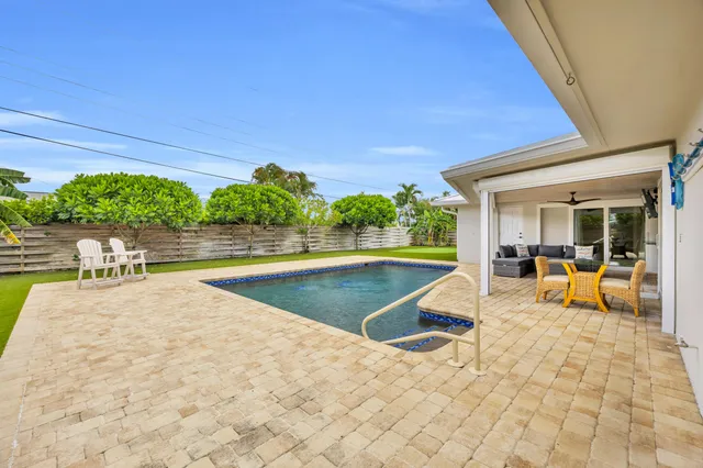 a view of house with swimming pool outdoor seating