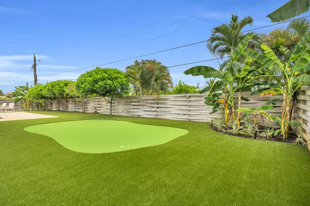 a view of a house with backyard and a tree