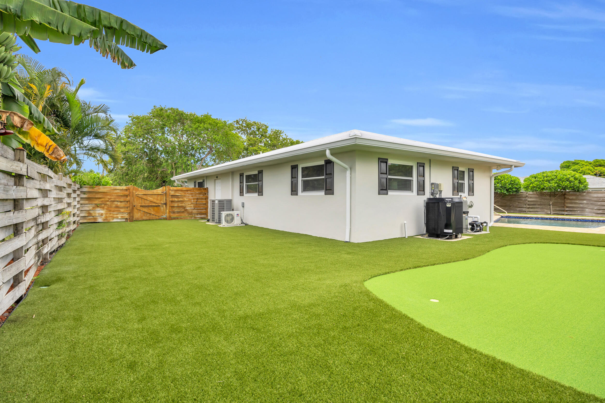 11 Southeast Splitrail Circle Jupiter, FL 33469 - Photo 42 of 48 a view of a house with backyard and a tree