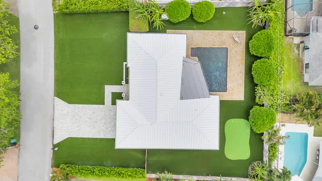an aerial view of a house with a garden and swimming pool