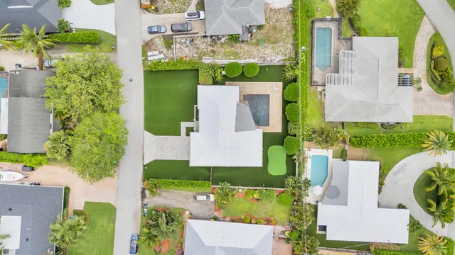 an aerial view of residential houses with outdoor space and street view