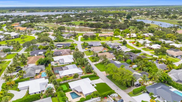 an aerial view of residential building with outdoor space and trees
