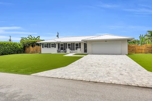 a view of a house with a swimming pool and a yard