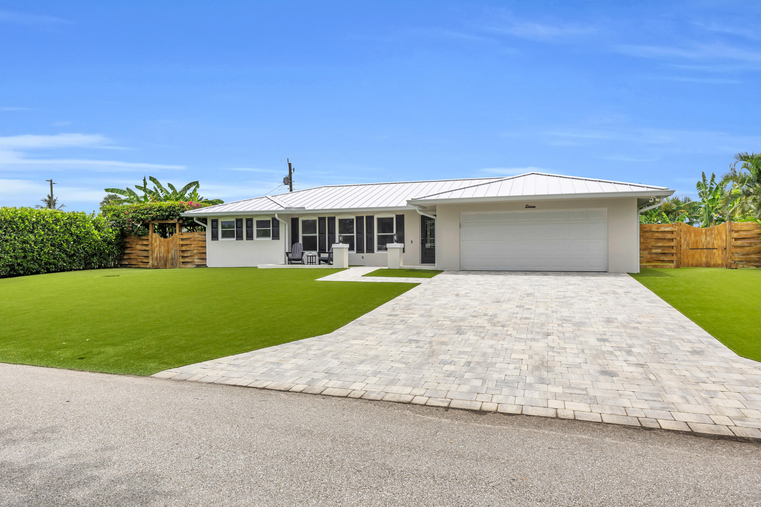 11 Southeast Splitrail Circle Jupiter, FL 33469 - Photo 5 of 48 a view of a house with a swimming pool and a yard