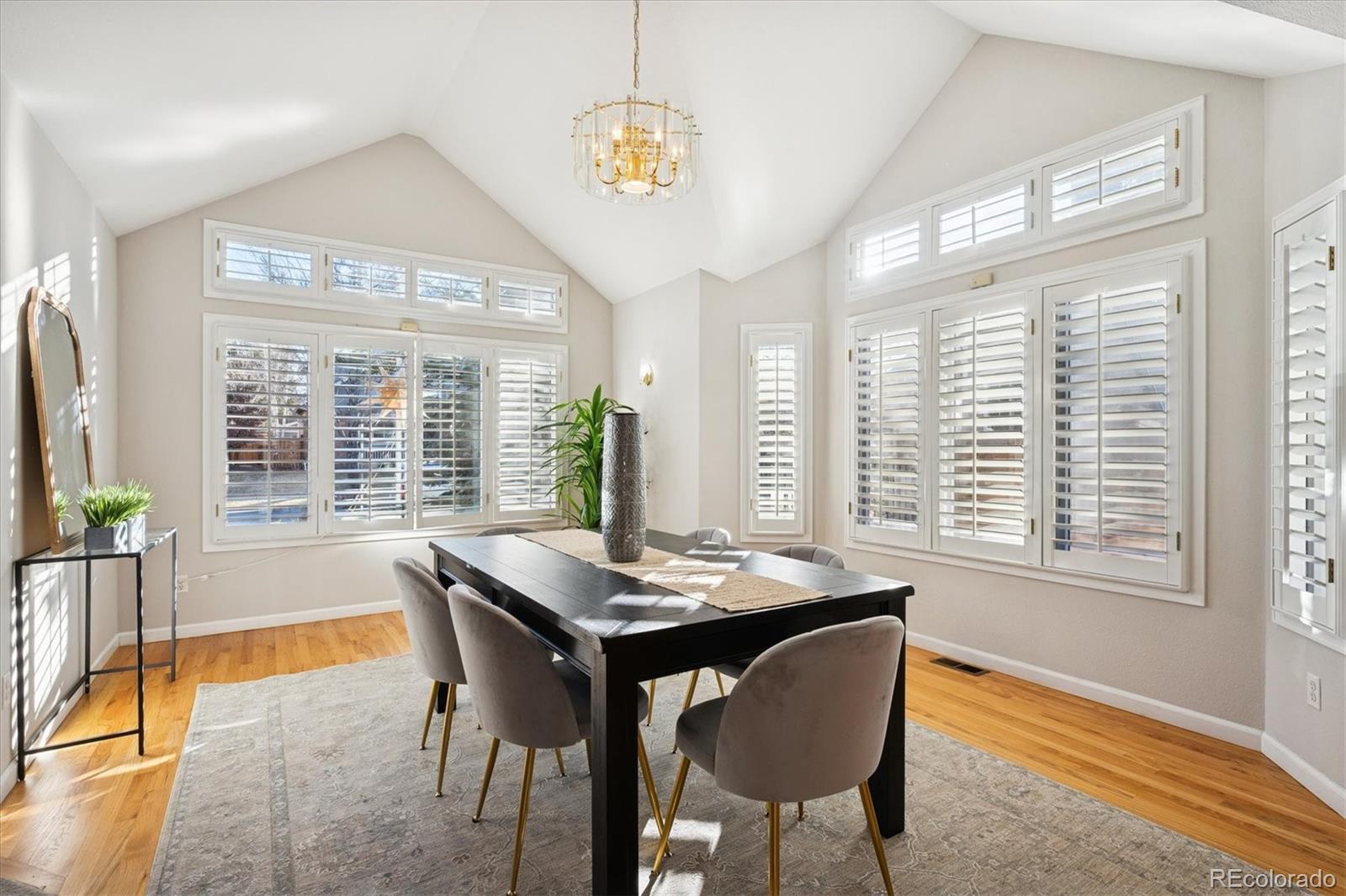 2363 South Adams Street Denver, CO 80210 - Photo 12 of 50 a dining room with furniture a chandelier and wooden floor