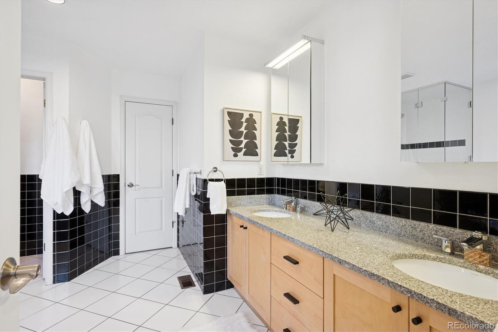 2363 South Adams Street Denver, CO 80210 - Photo 27 of 50 a bathroom with a sink and a mirror
