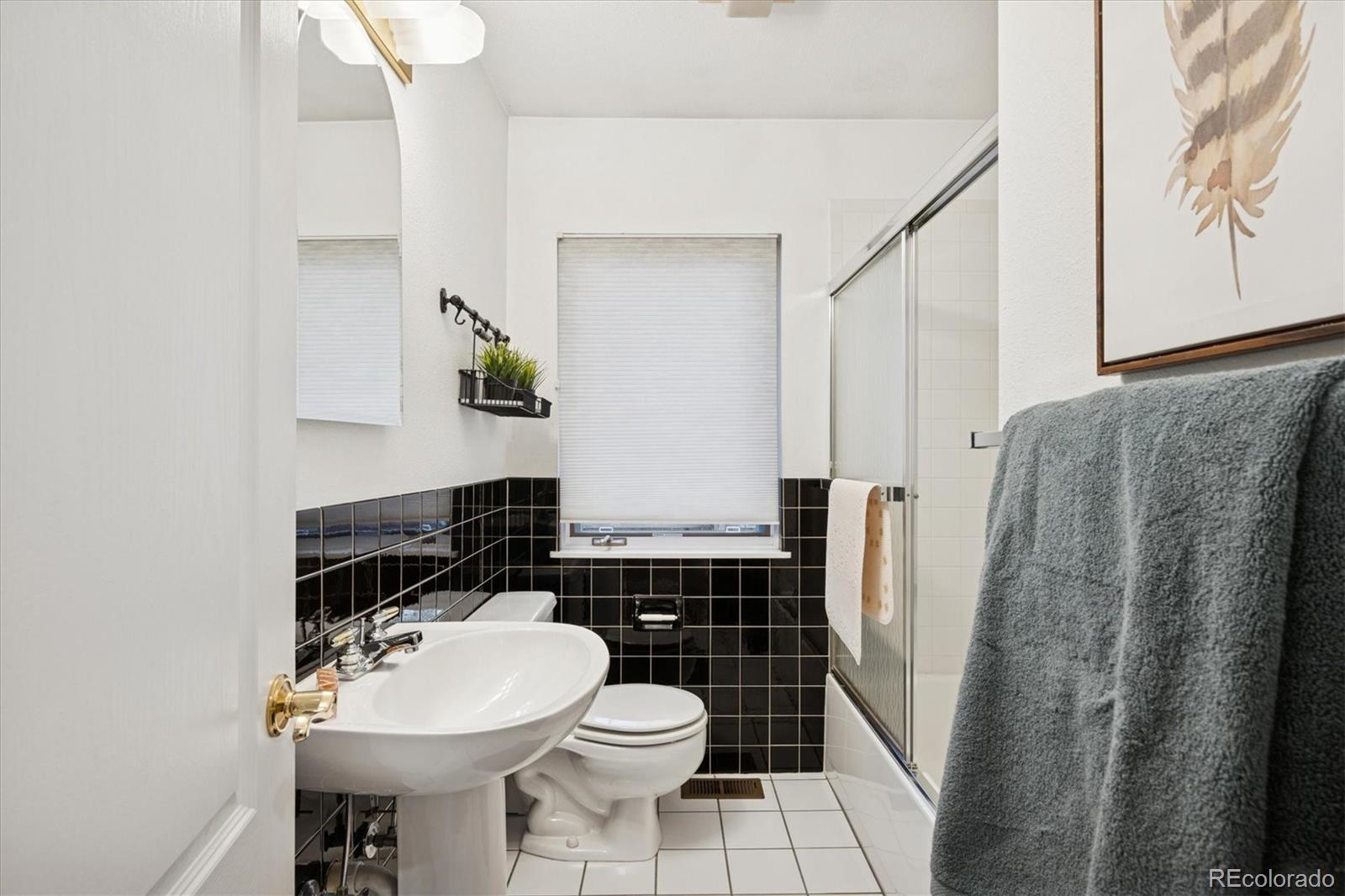 2363 South Adams Street Denver, CO 80210 - Photo 30 of 50 a bathroom with a sink and toilet