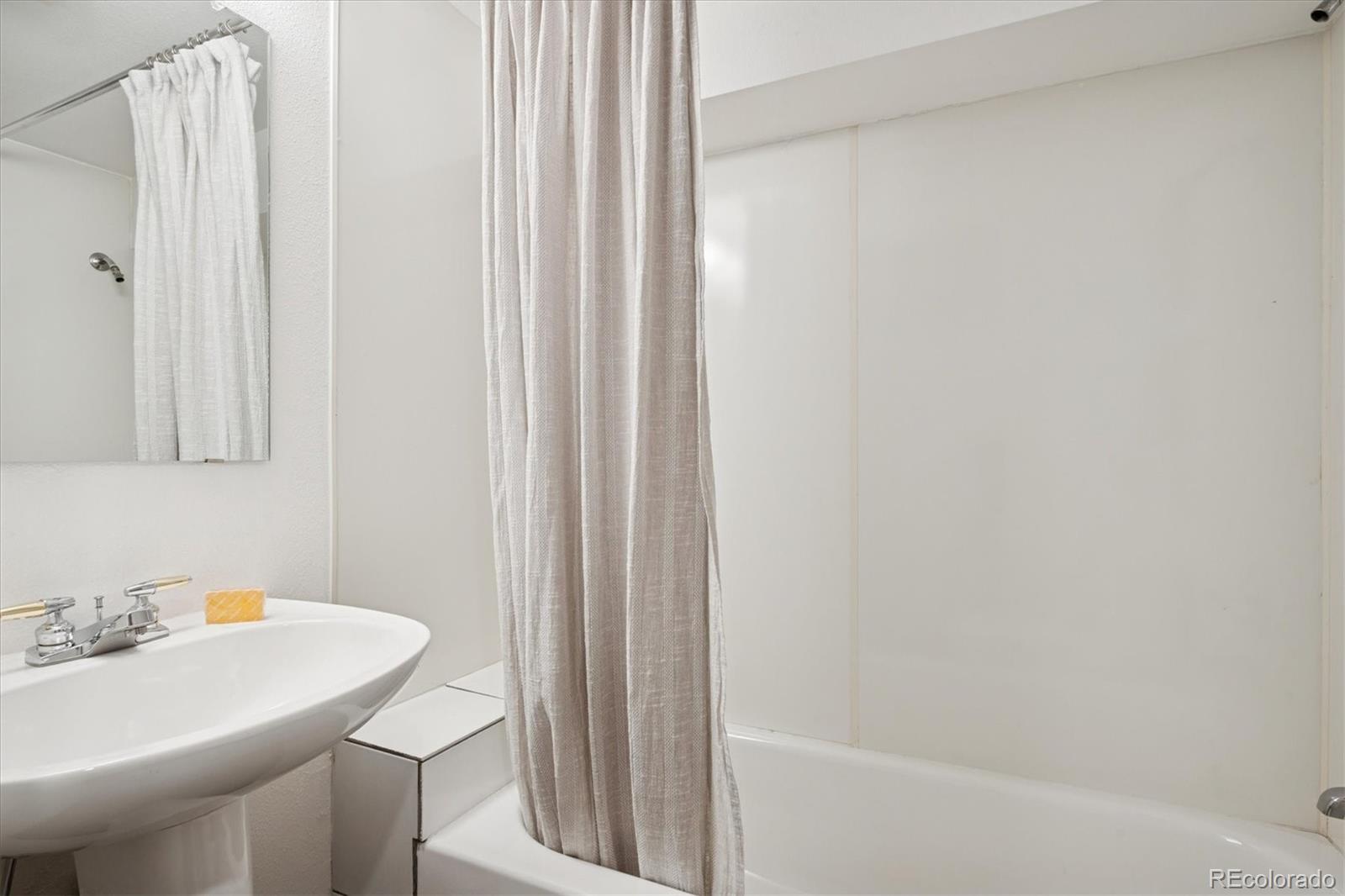 2363 South Adams Street Denver, CO 80210 - Photo 34 of 50 a bathroom with a sink a toilet and shower