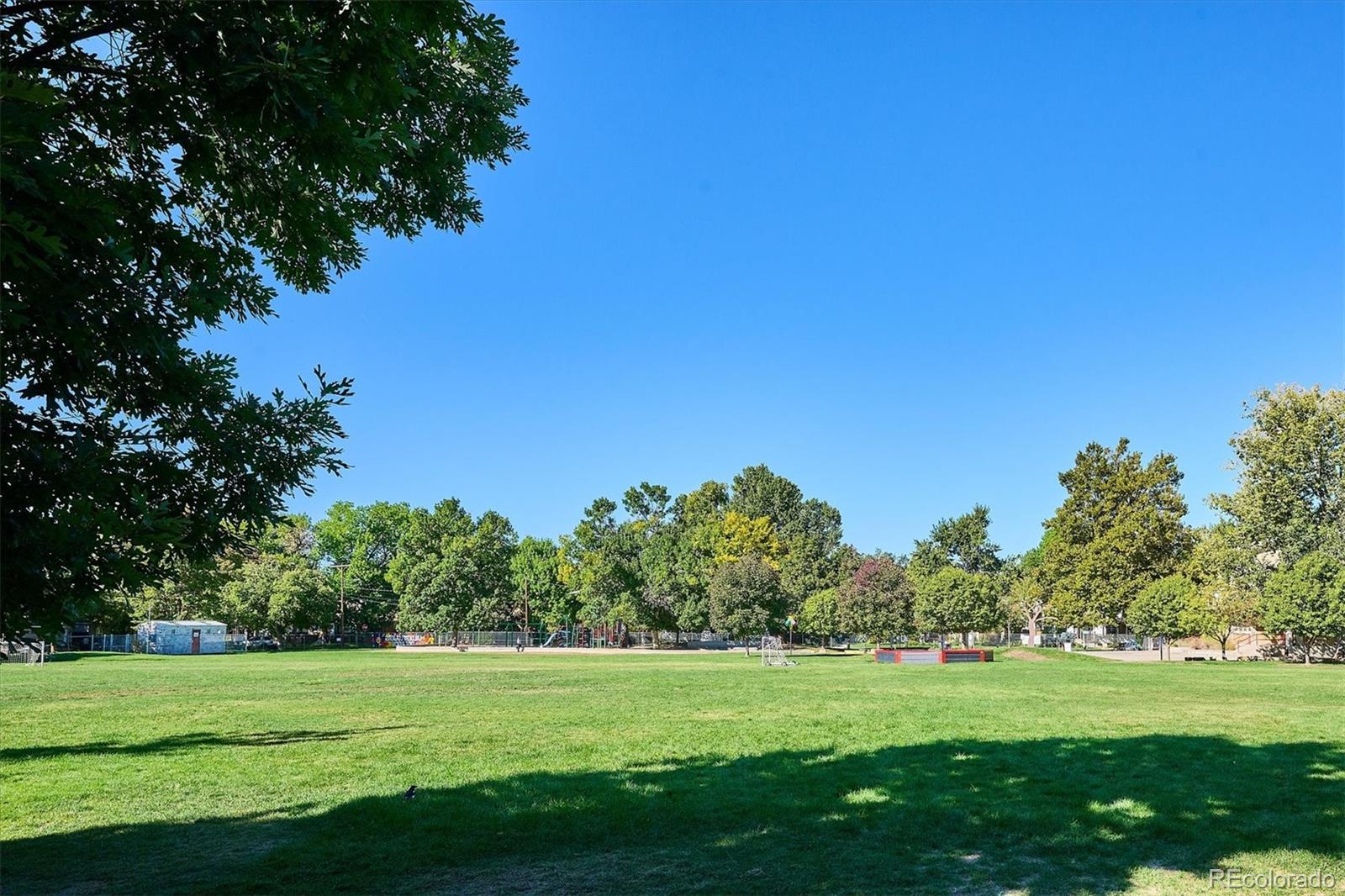 2363 South Adams Street Denver, CO 80210 - Photo 46 of 50 a view of a grassy field with trees