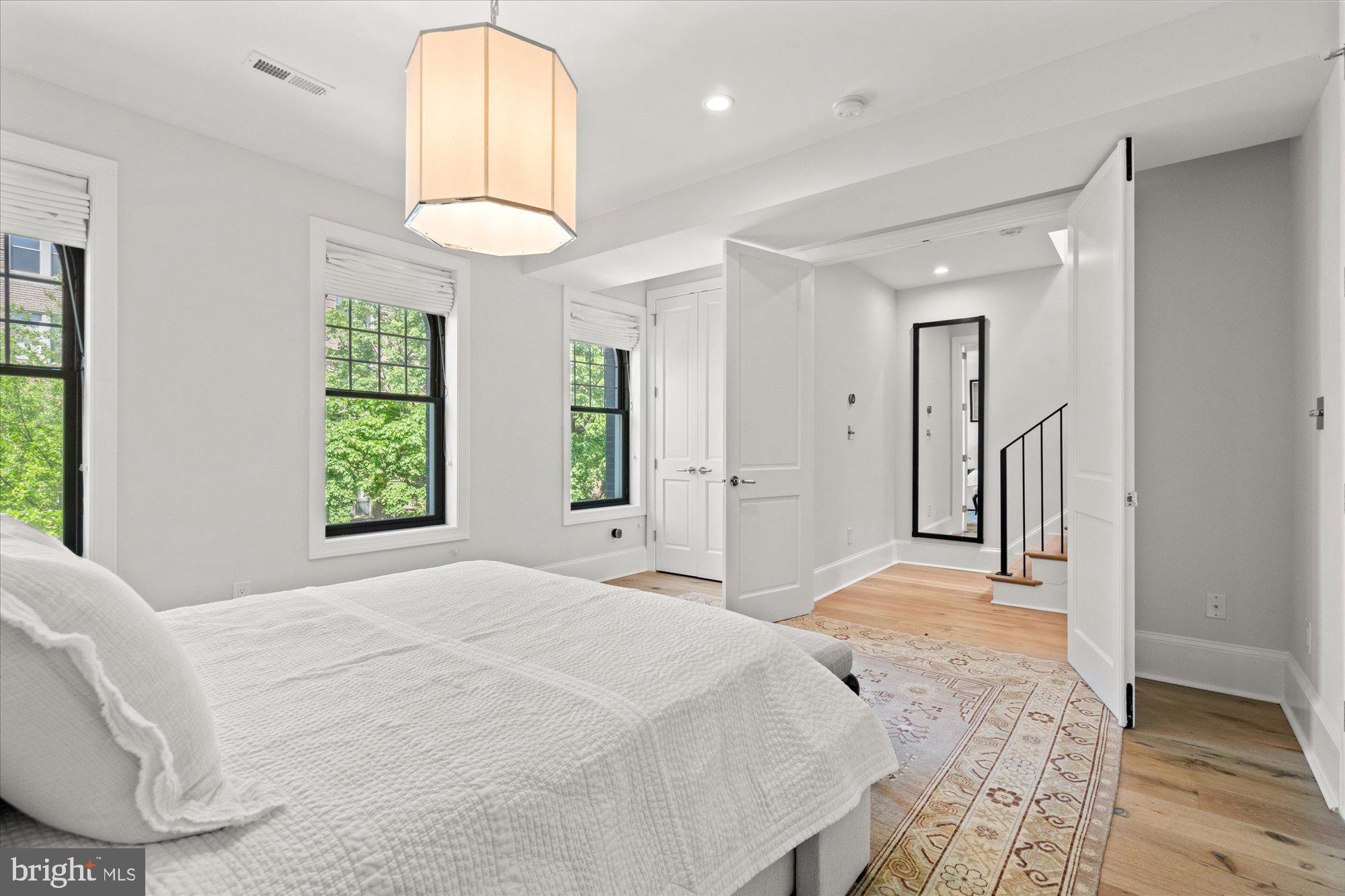 2610 Garfield Street Northwest Washington, DC 20008 - Photo 21 of 51 a bedroom with a bed and a chandelier