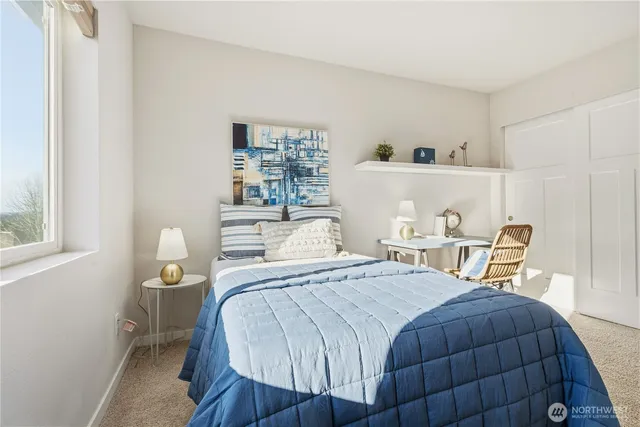 a bedroom with a bed a table and chair