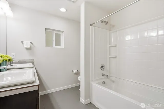 a bathroom with a tub a sink and a shower
