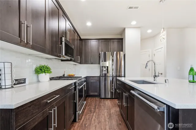 a kitchen with a sink stainless steel appliances a sink and counter space