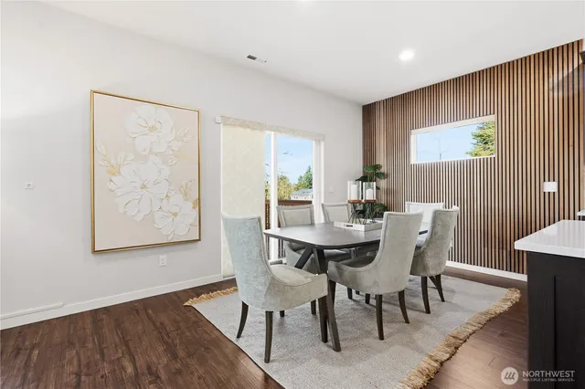 a view of a dining room with furniture and wooden floor