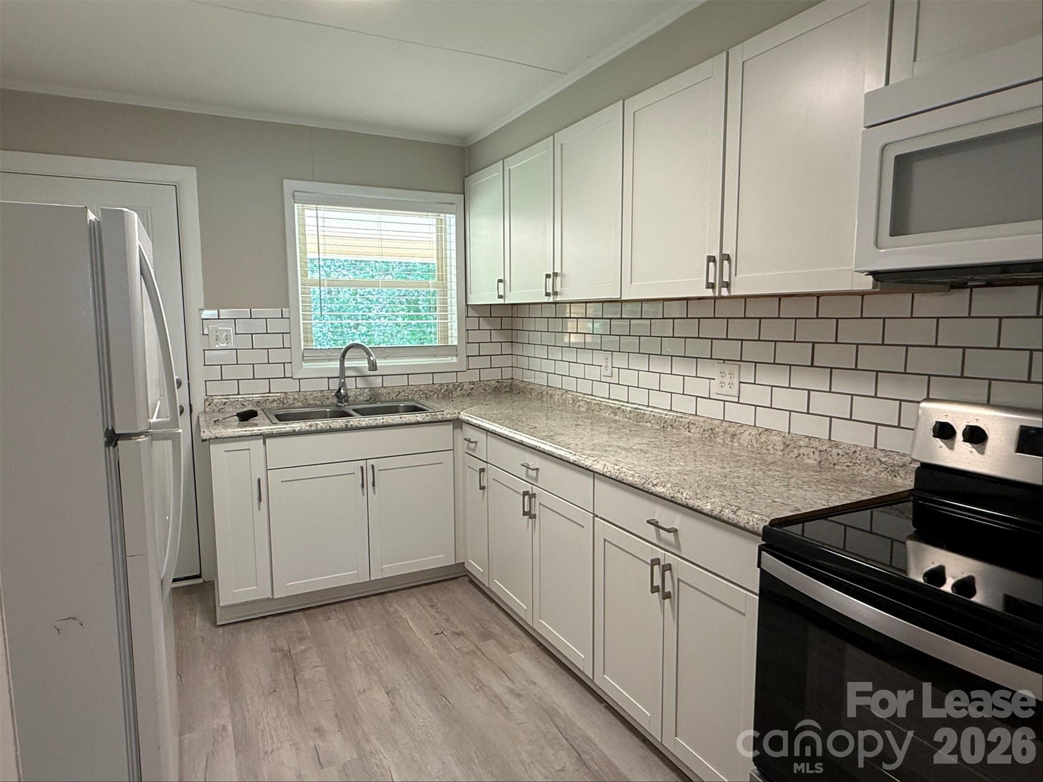 1771 River Road Lincolnton, NC 28092 - Photo 4 of 12 a kitchen with a sink stove and cabinets