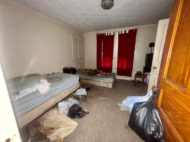 a view of a room with furniture and clothes