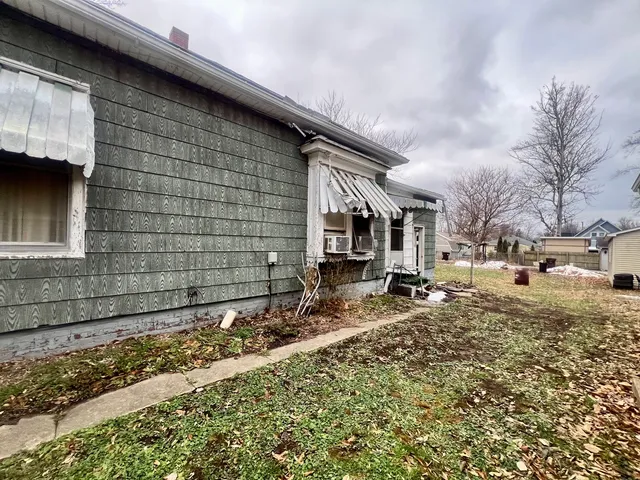 a backyard of a house with parked cars
