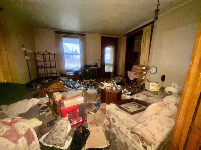 a bed room with a bed mirror and a chandelier