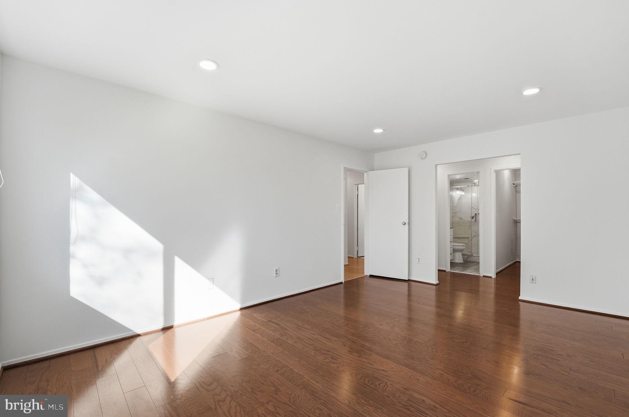 2817 Jermantown Road, Unit 107 Oakton, VA 22124 - Photo 11 of 28 a view of an empty room with wooden floor