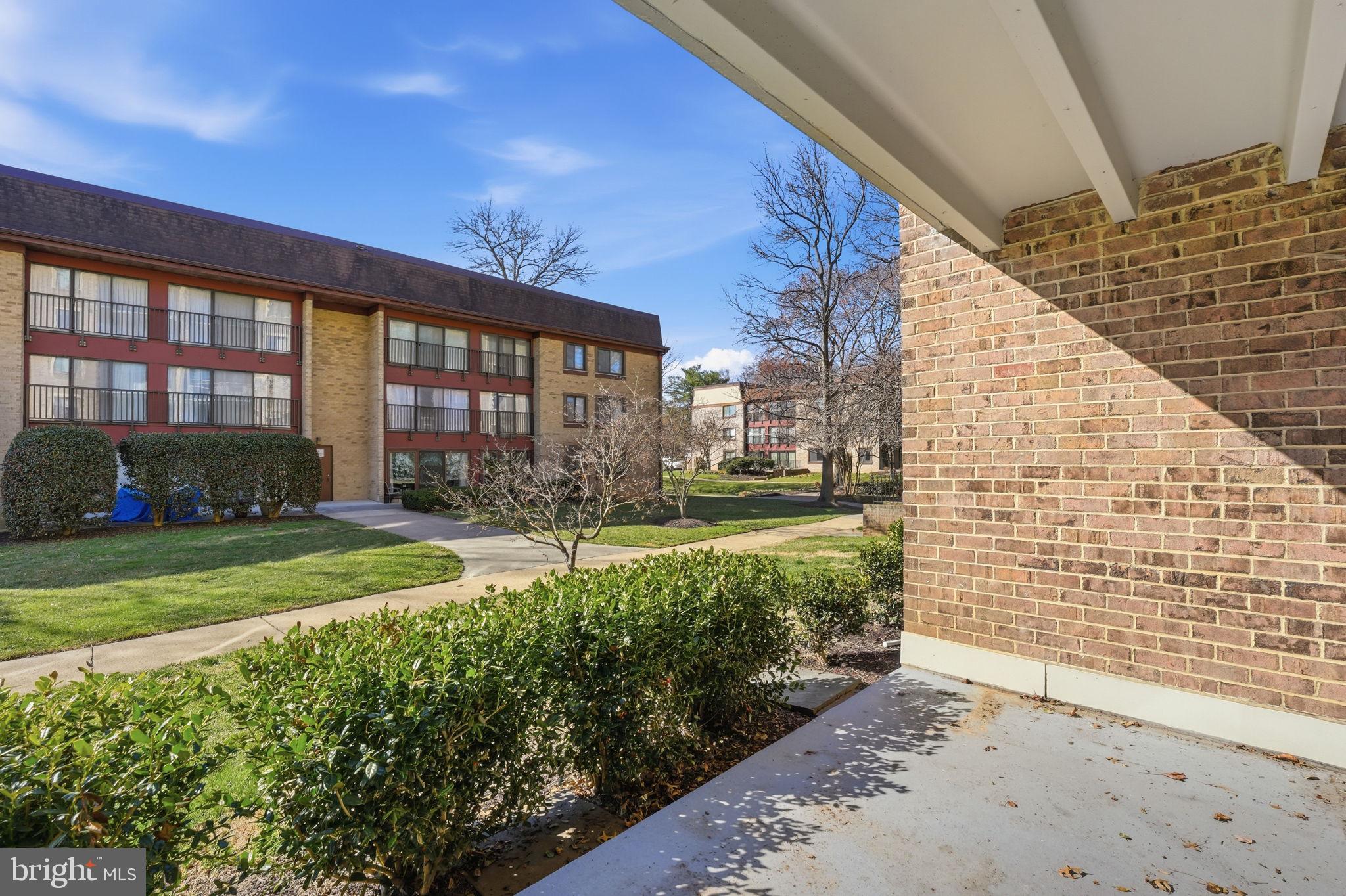 2817 Jermantown Road, Unit 107 Oakton, VA 22124 - Photo 18 of 28 a view of a house with backyard and sitting area