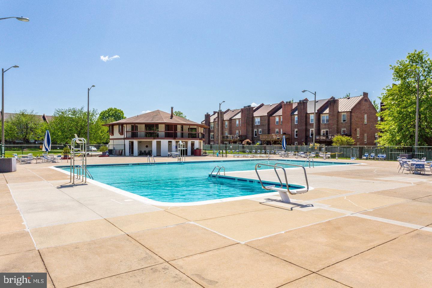 2817 Jermantown Road, Unit 107 Oakton, VA 22124 - Photo 21 of 28 a swimming pool with outdoor seating and yard
