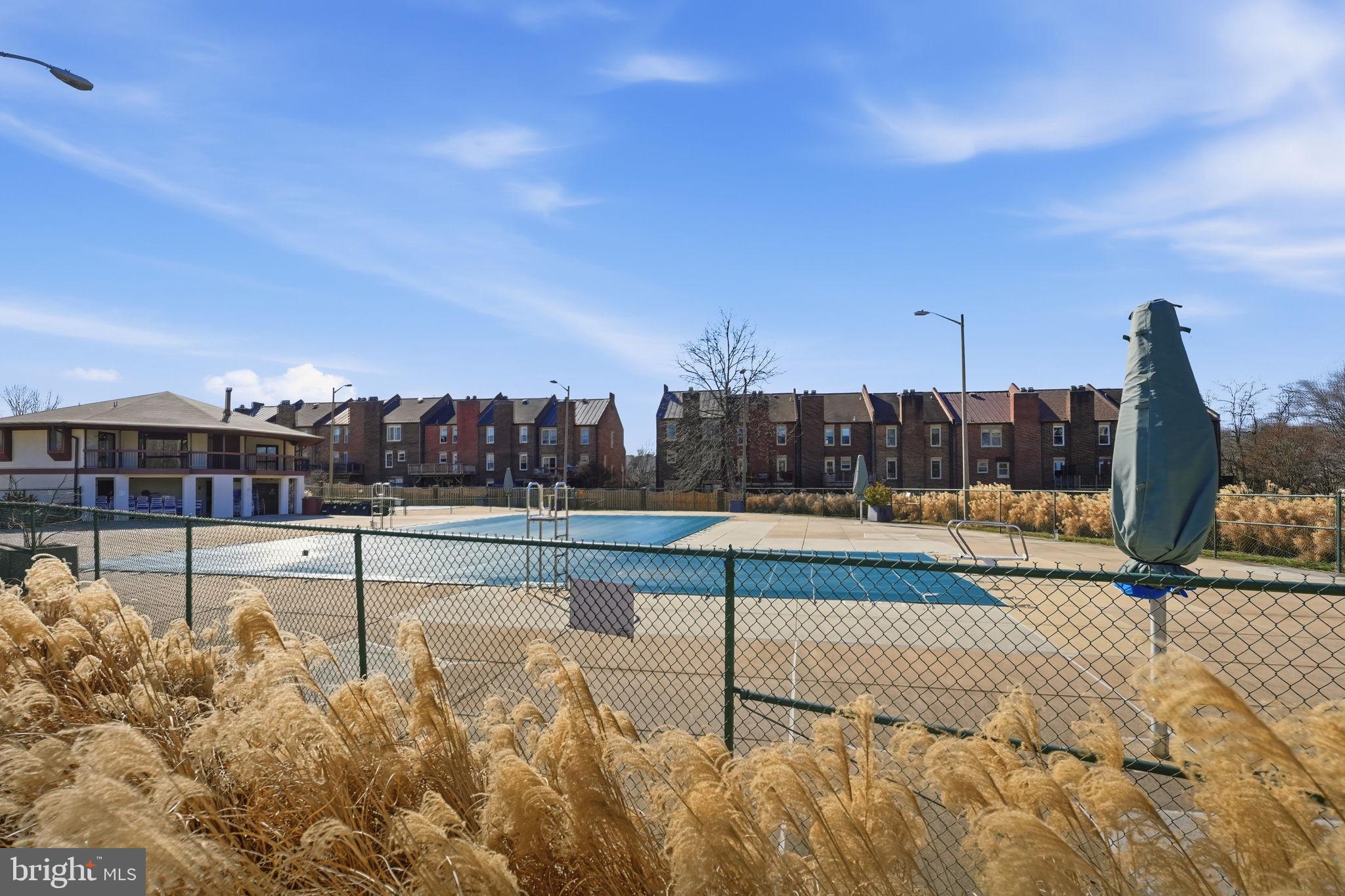 2817 Jermantown Road, Unit 107 Oakton, VA 22124 - Photo 23 of 28 a view of swimming pool with outdoor seating and city view